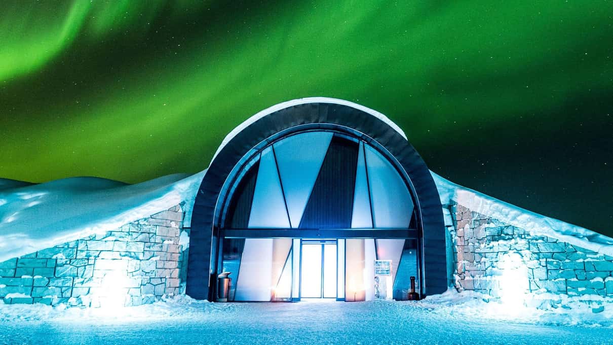 Green northern lights over the arched entrance of the Icehotel in Jukkasjärvi at night