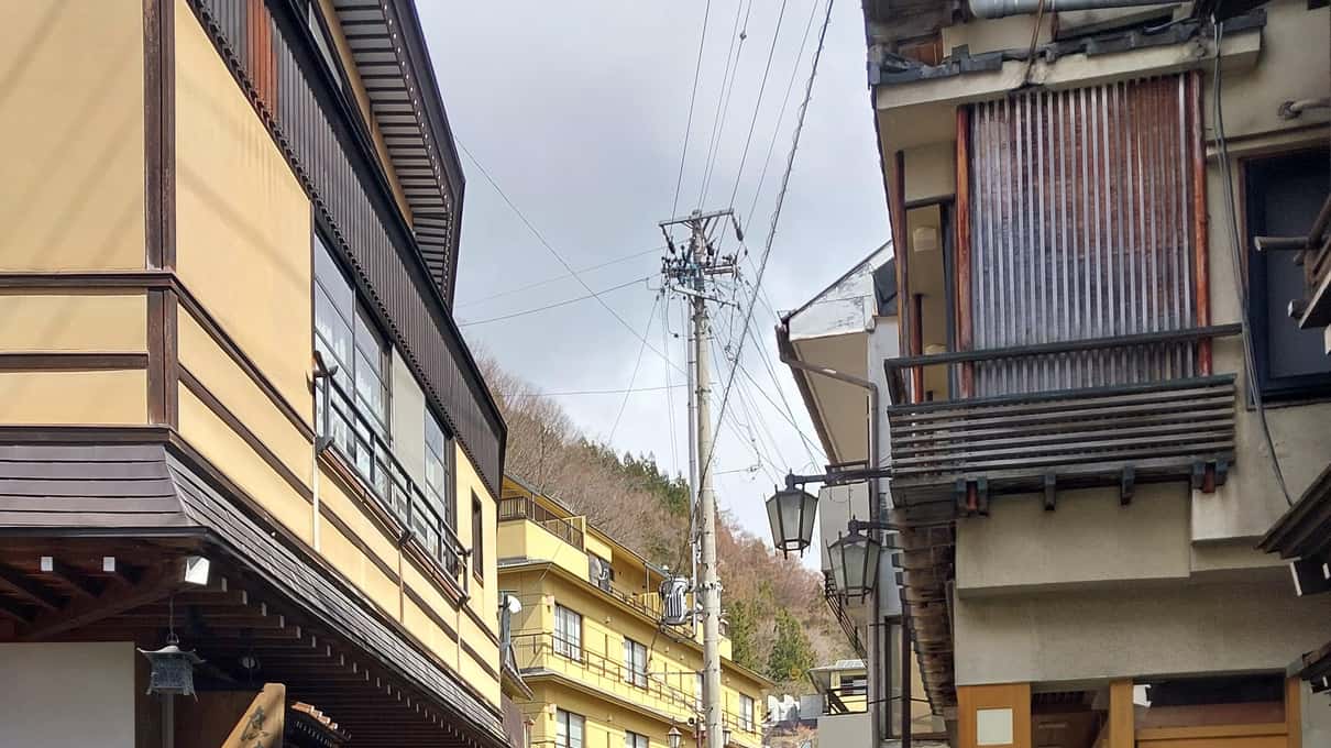 A narrow street in Shibu Onsen running between old wooden inns, a short drive below the monkey park
