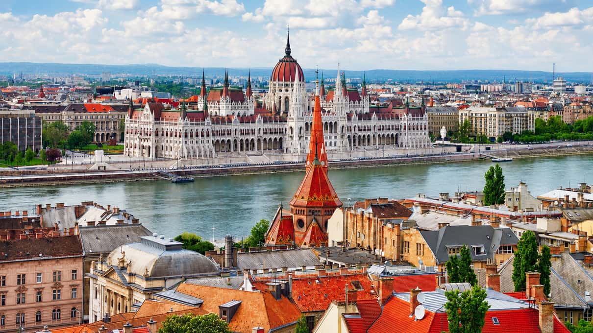 The Hungarian Parliament on the Danube in Budapest, seen across the river with the city rooftops in front