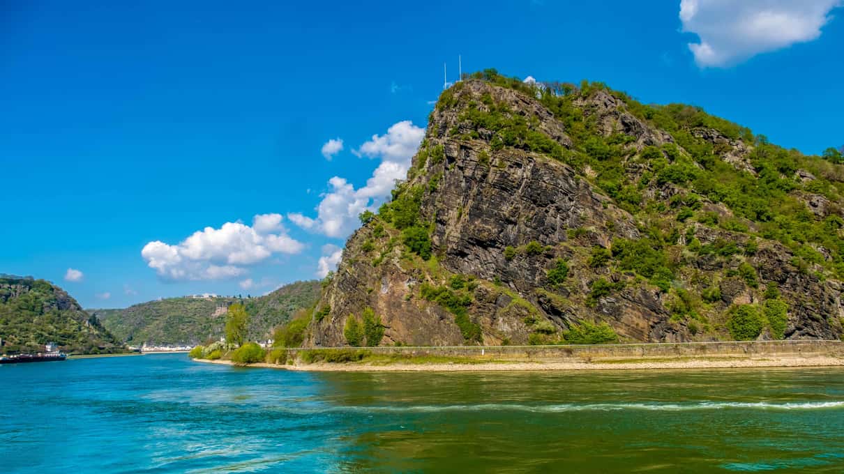 The Loreley rock rising above a sharp bend of the Rhine on a sunny day