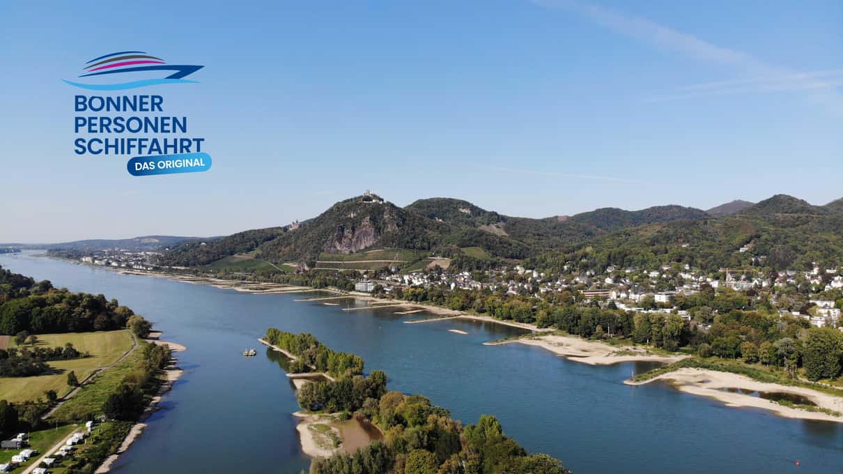 The Rhine bending past wooded hills and islands south of Bonn, seen from high above the water