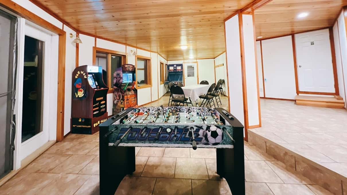 Games room at the aurora lodge near Madeline Lake with arcade machines and a foosball table