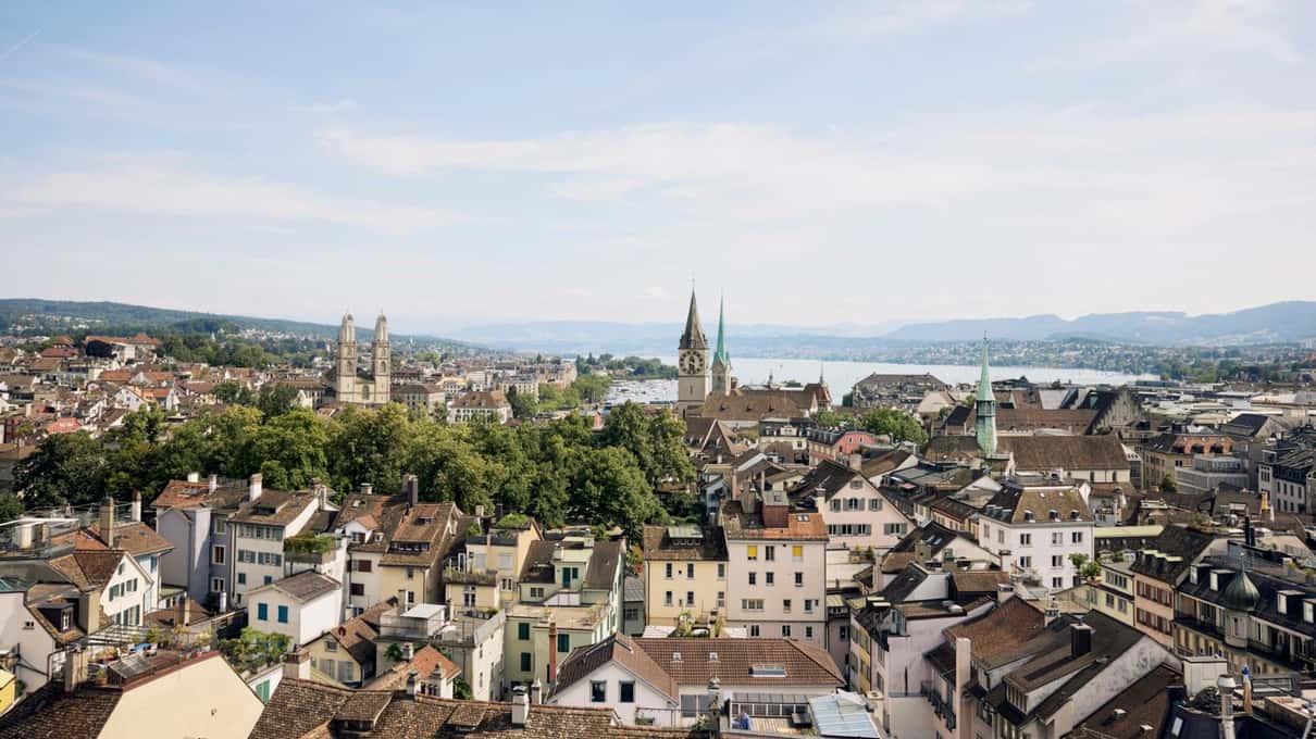 A view across the rooftops of Zurich toward the lake, seen from above the city