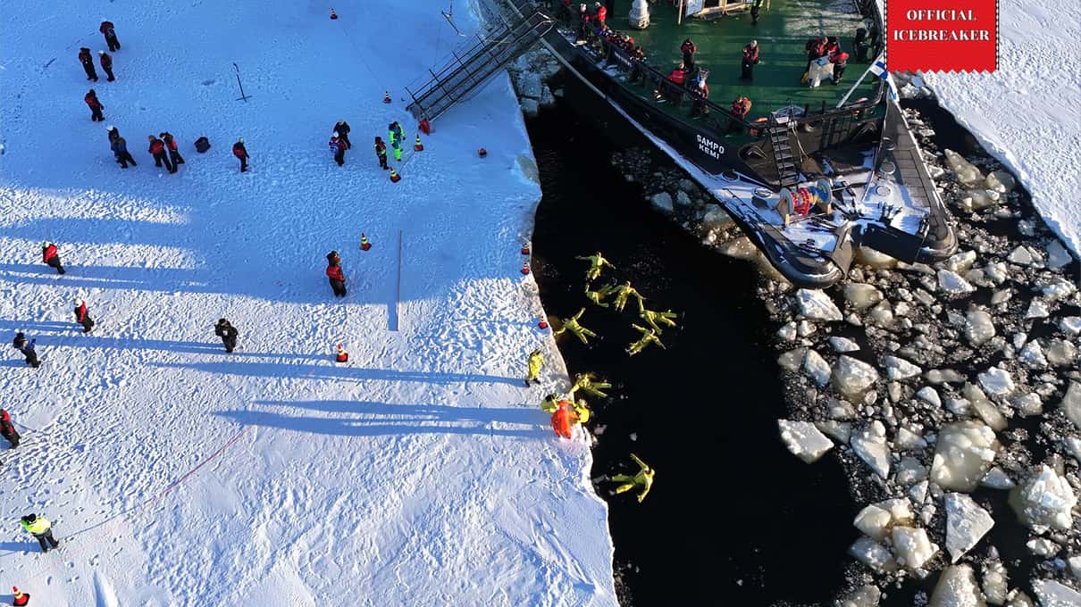 Aerial view of guests on the sea ice and floaters in the broken channel beside Sampo