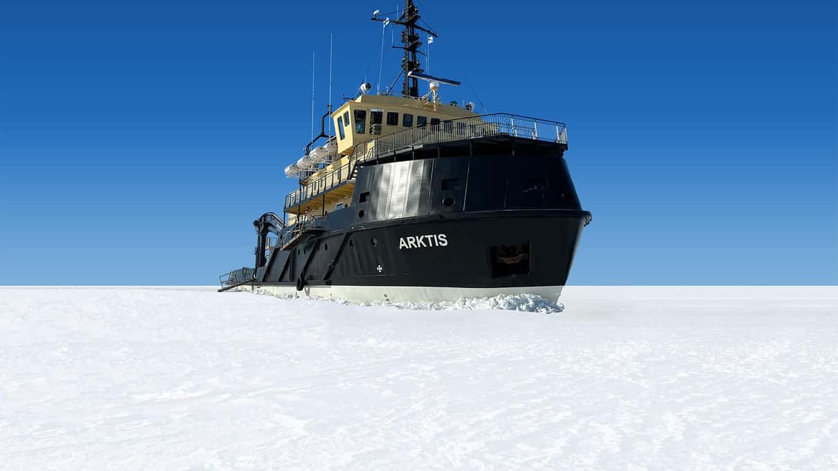 The icebreaker Arktis with its black bow resting in snow-covered sea ice under a deep blue sky