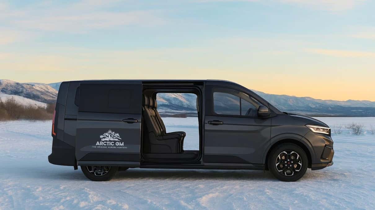 Arctic GM's black 4x4 van parked on packed snow under a pale winter sky