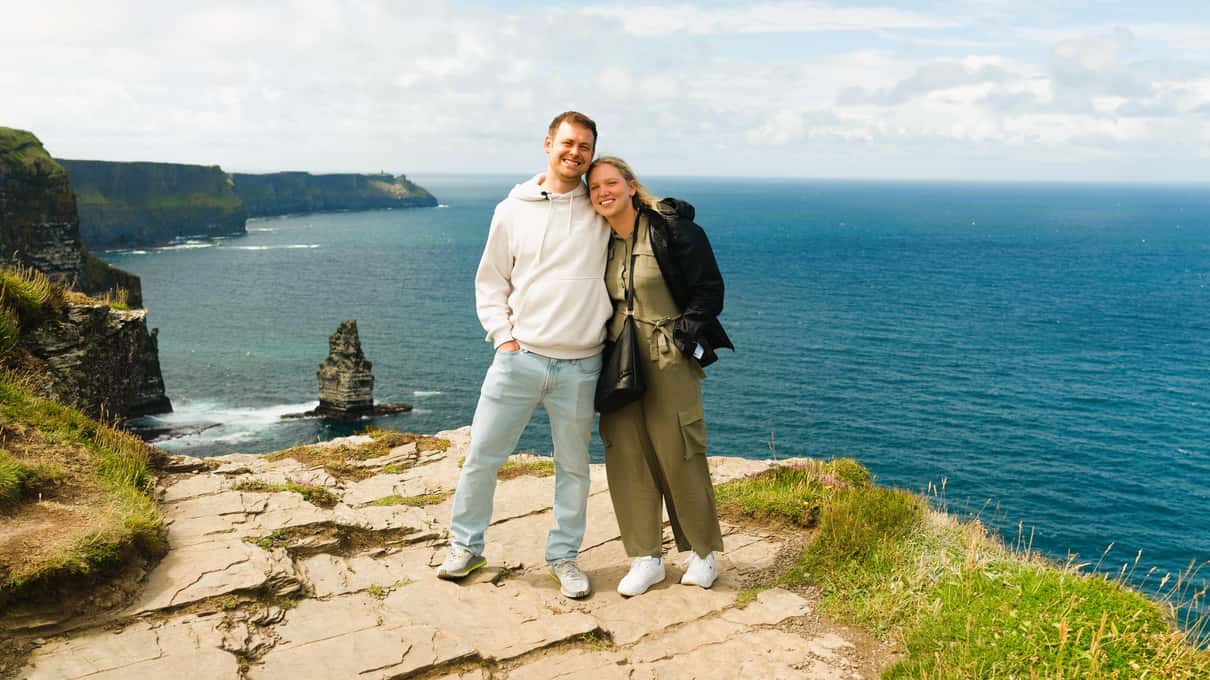 Walkers on the Cliffs of Moher path above Galway Bay