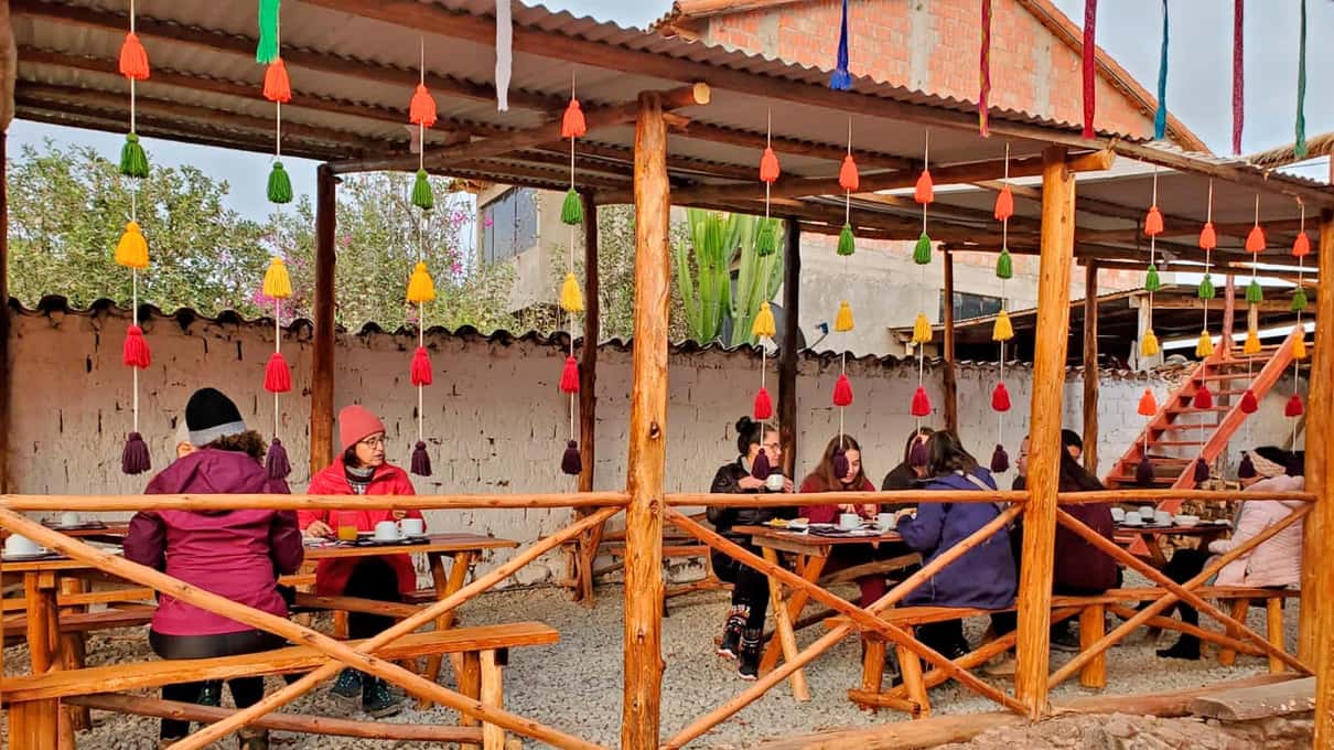A long restaurant hall with rows of orange tables and a buffet counter where hikers eat lunch