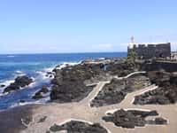 Lava rock pools and seaside fortress