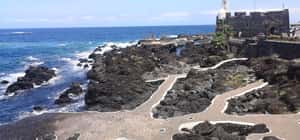 Lava rock pools and seaside fortress