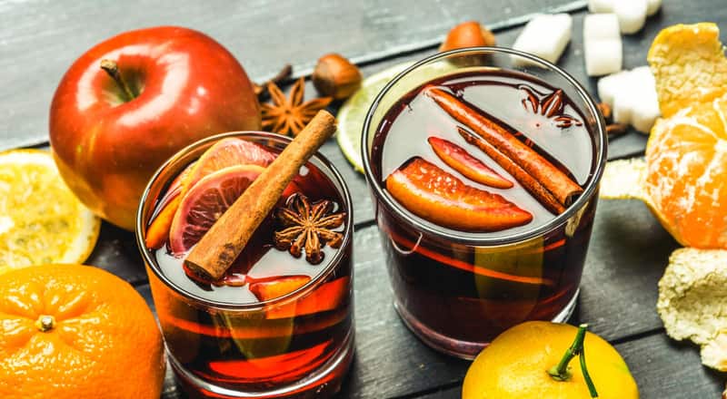 Two glasses of mulled wine with cinnamon, star anise and orange