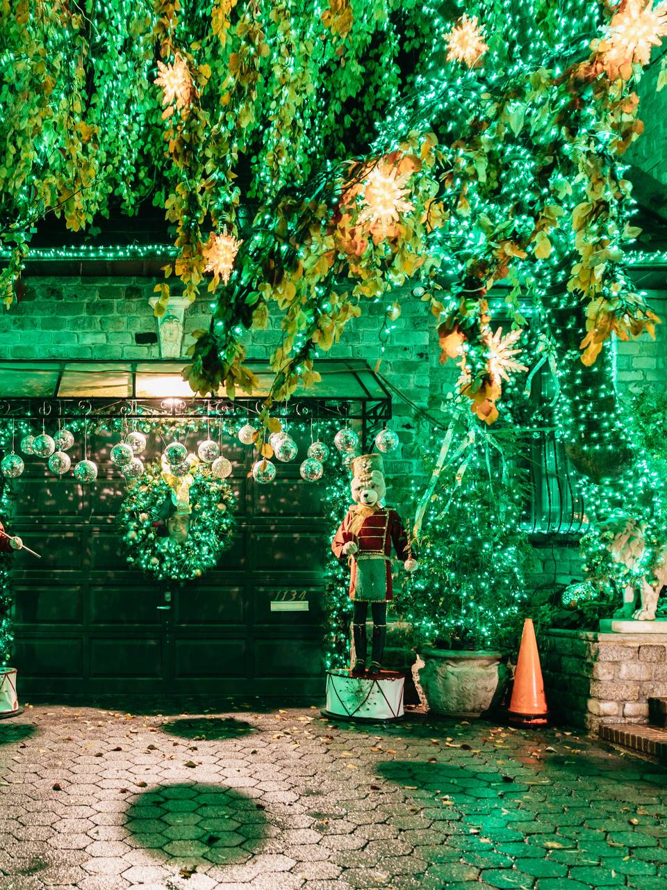 Front yard and garage covered in green lights