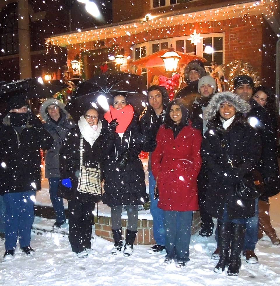 Group of visitors in the snow at night