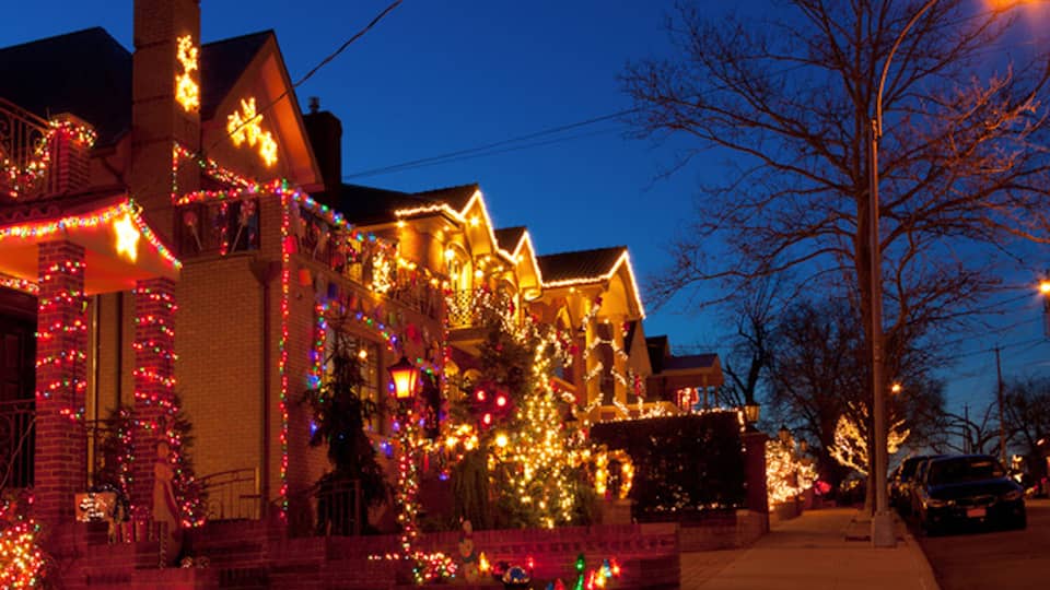Street of lit houses at dusk
