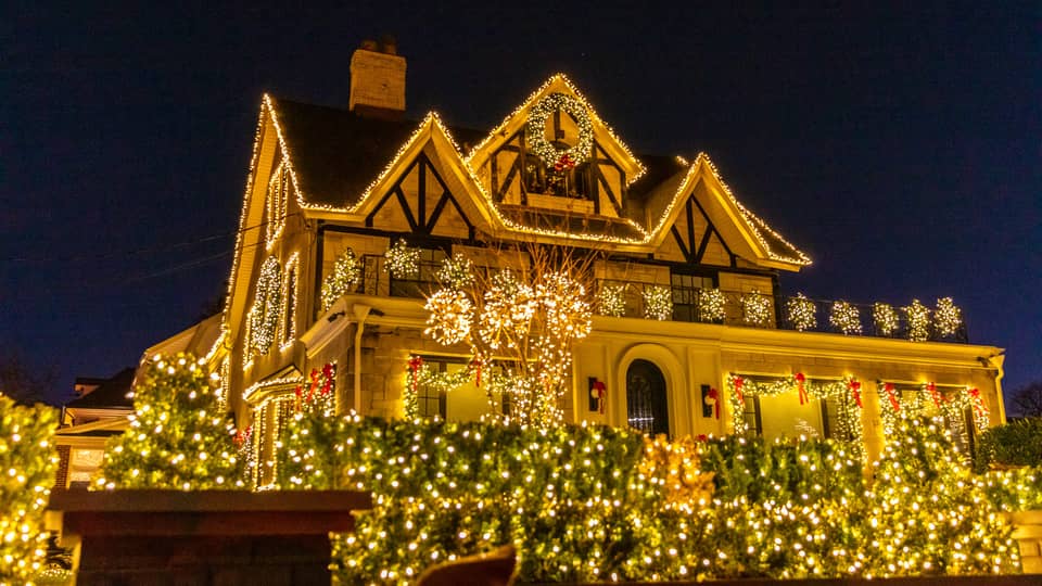 Tudor-style house outlined in warm white lights