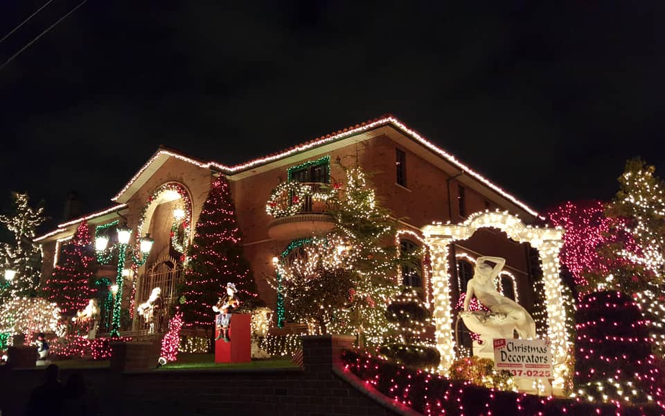 House with an illuminated arch and decorated trees