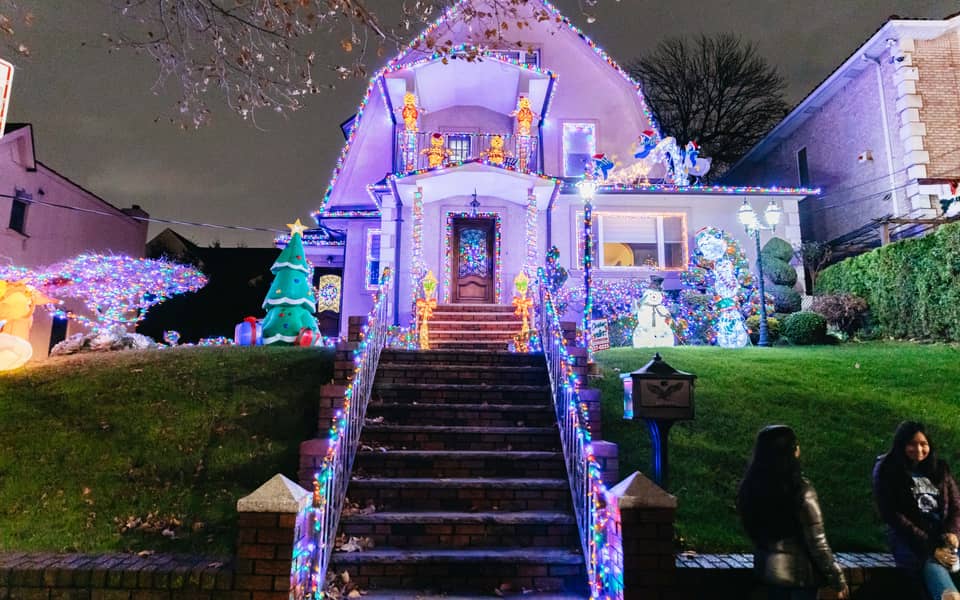 Purple-lit house with a staircase and small trees