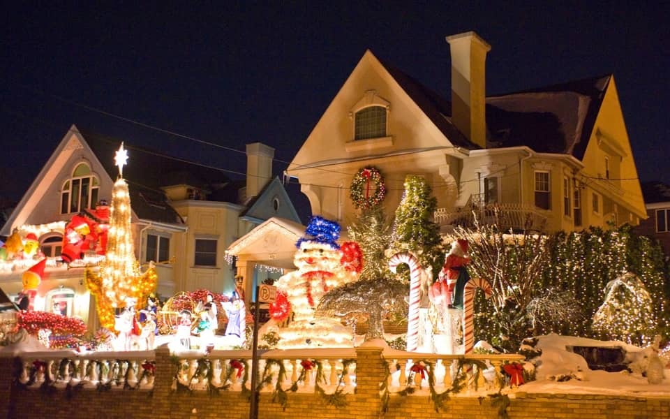 White-lit house with snowmen on the front wall