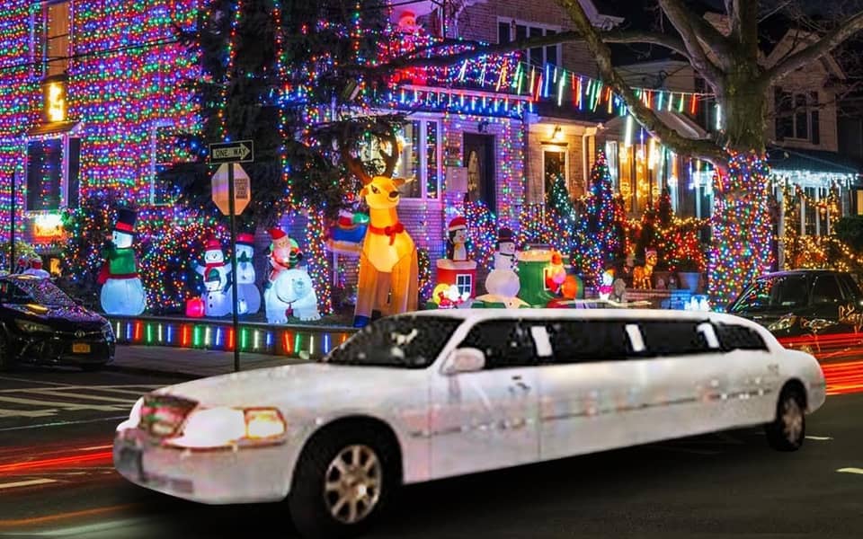 White stretch limousine passing a brightly lit decorated house