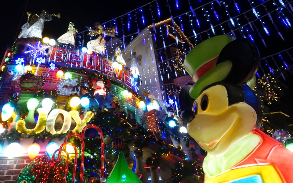 Large toy character with a 'Joy' light sign