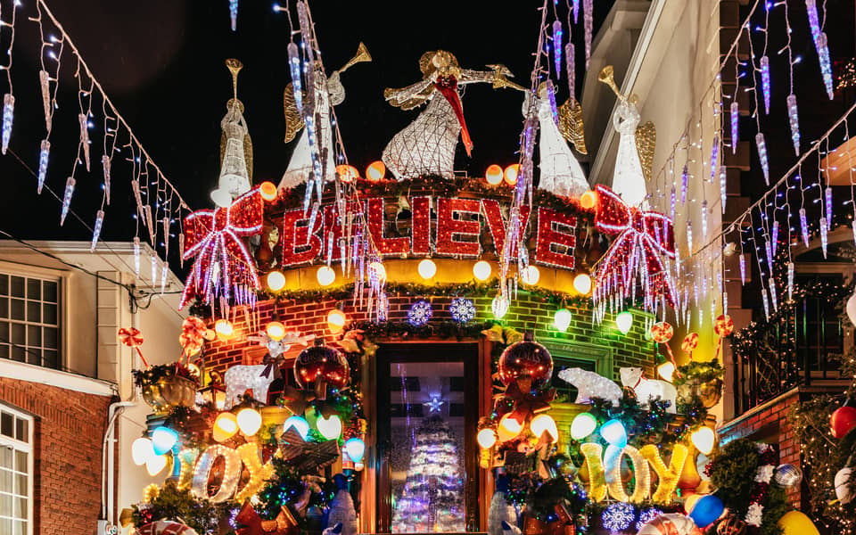 House with a 'Believe' sign, angels and heavy garlands