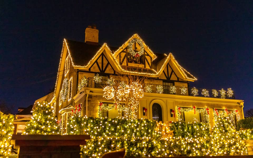 Tudor-style house outlined in warm white lights
