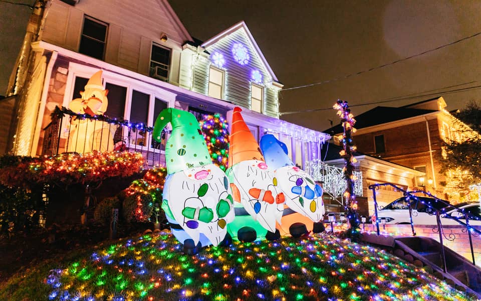 Inflatable gnomes on a lawn of coloured lights
