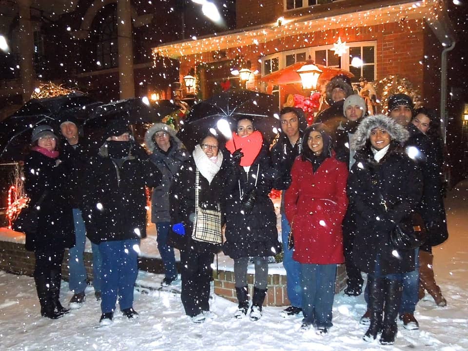 Group of visitors in the snow at night