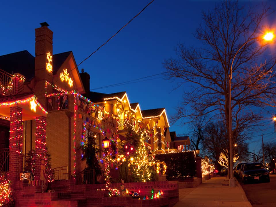 Street of lit houses at dusk