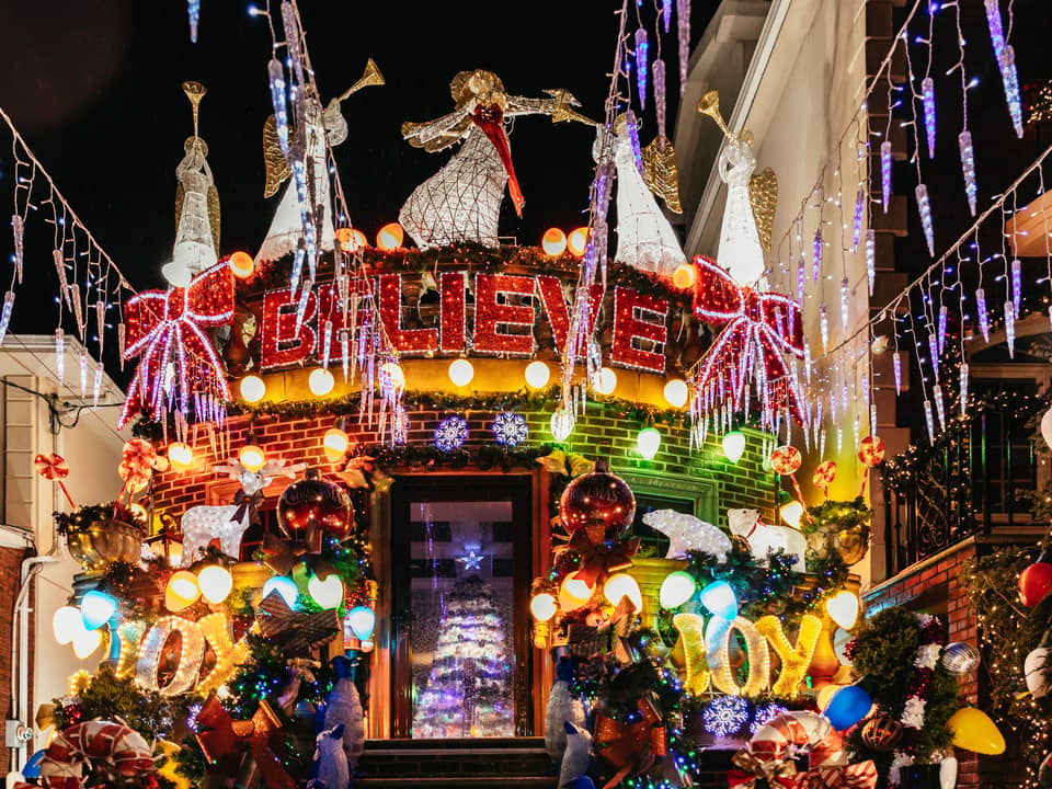 House with a 'Believe' sign, angels and heavy garlands