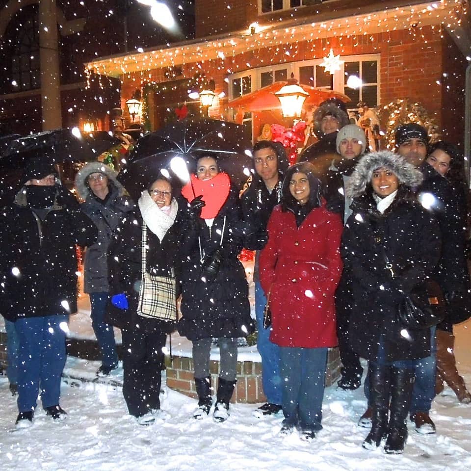 Group of visitors in the snow at night