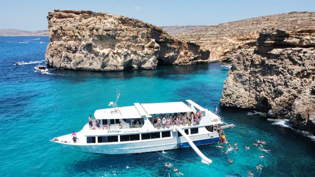 Cruise boat anchored off Comino in turquoise water