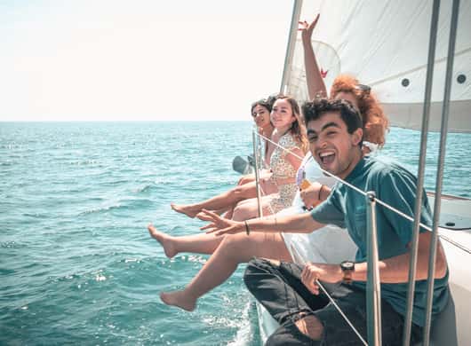 Gasten op dek met uitzicht op Ibiza-kust