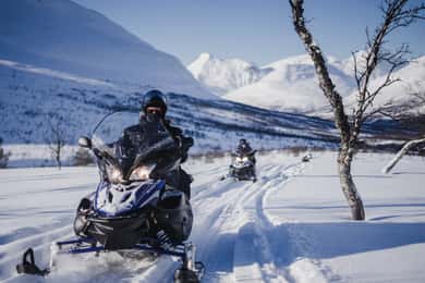 From Tromsø: Snowmobiling at Camp Tamok & Snow Park Visit