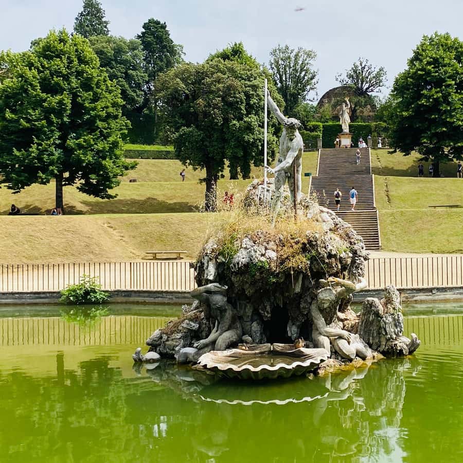 Visitors exploring Boboli Gardens terraces with Florence skyline in background