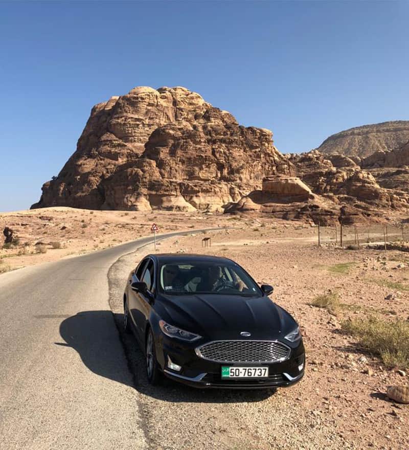 A private transfer car on the desert road to Petra