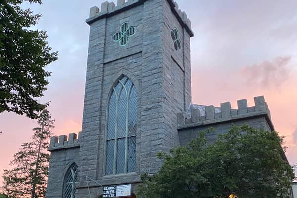 A stone church tower against the evening sky