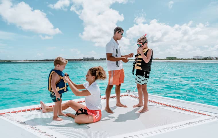 Kids getting ready to snorkel on a catamaran