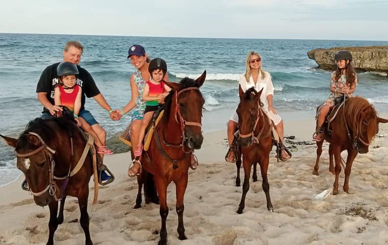 Family on horseback on a beach