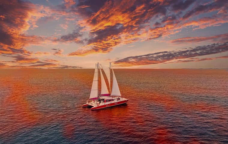 Catamaran under sail at sunset off Aruba