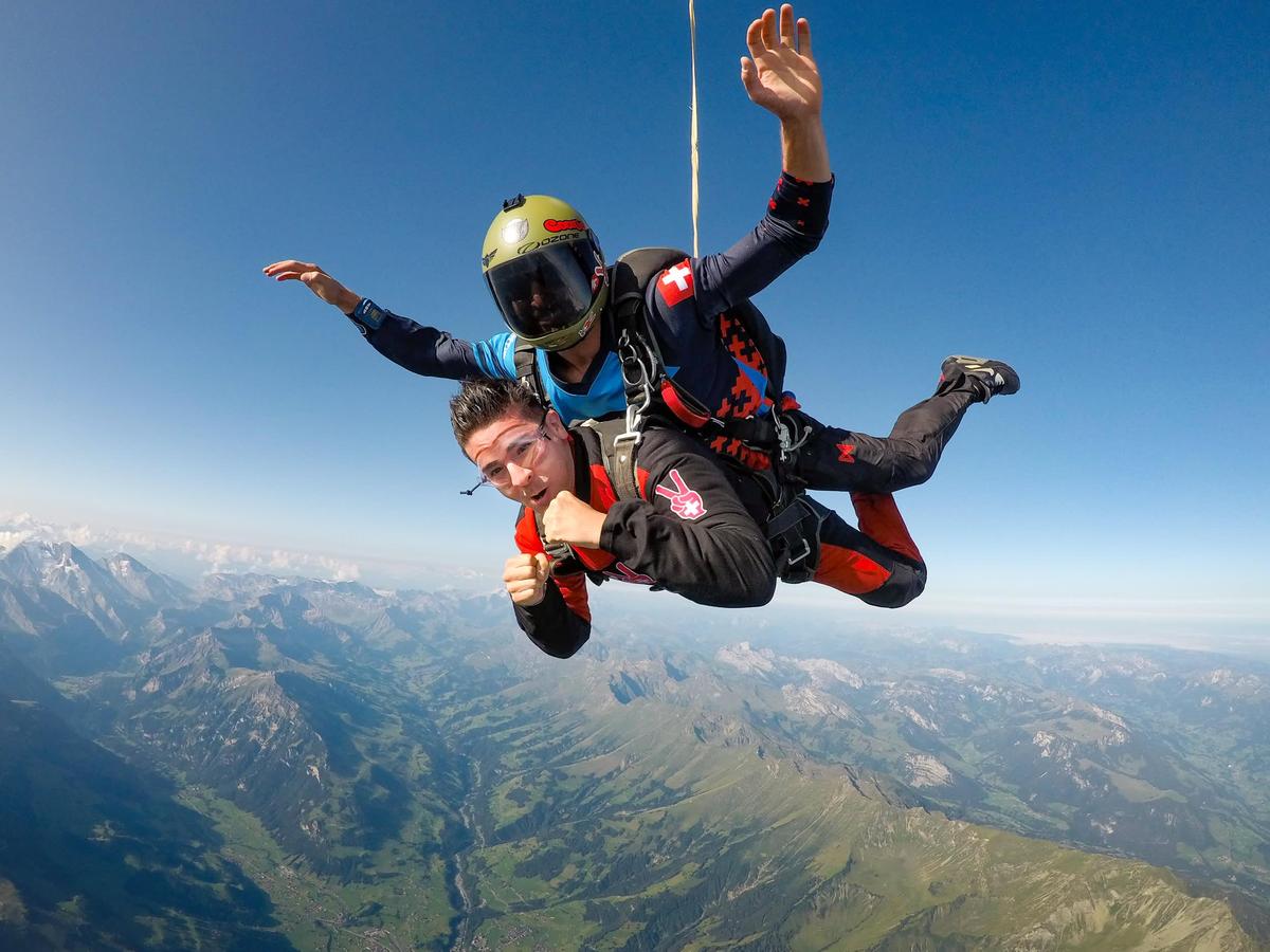 Skydiver in freefall over the Bernese Oberland with Swiss Alps in view