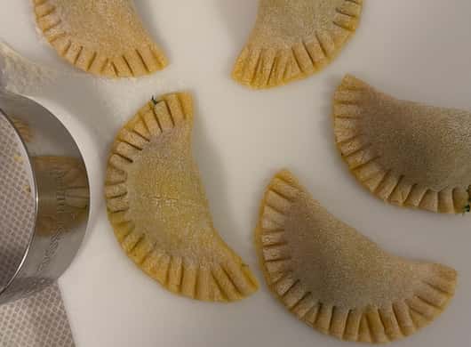 Deelnemers die pasta vormen tijdens een kookworkshop in Bologna