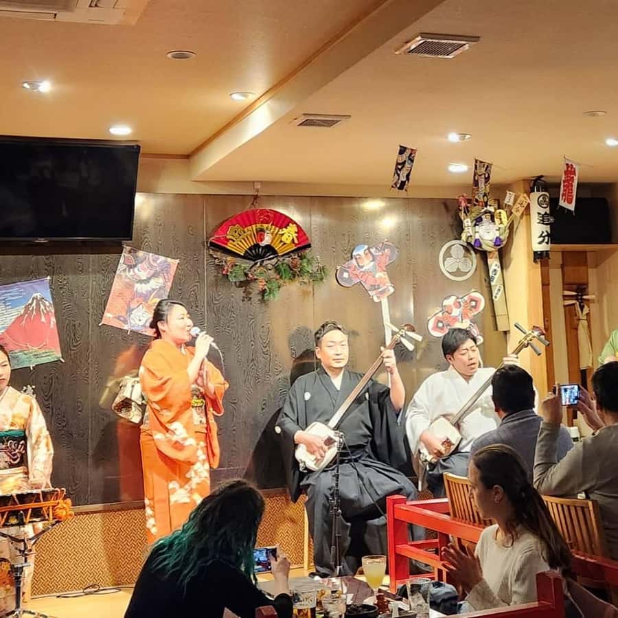 Tsugaru shamisen performance over traditional dinner | GetYourGuide