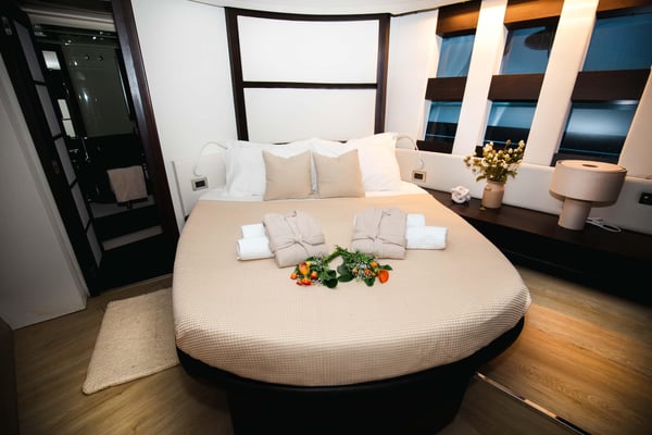 Luxury private yacht cruising the Bay of Naples at sunset with guests enjoying drinks near Ischia and Procida islands. Luxury private yacht cruising the Bay of Naples at sunset with guests enjoying drinks near Ischia and Procida islands.