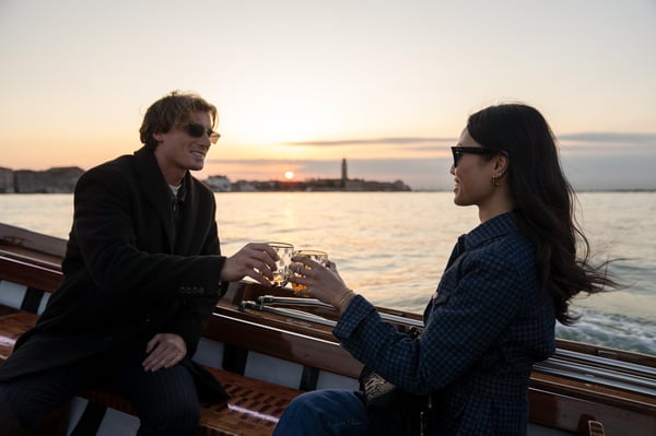 Romantic private sunset boat cruise on the Venetian lagoon with a couple toasting with prosecco in front of historic Venice skyline. Romantic private sunset boat cruise on the Venetian lagoon with a couple toasting with prosecco in front of historic Venice skyline.