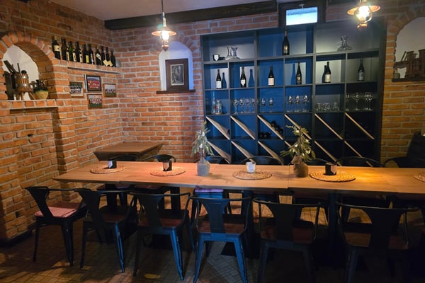 Sunset wine tasting in a Croatian vineyard near Zagreb with glasses and local delicacies on a rustic table. Sunset wine tasting in a Croatian vineyard near Zagreb with glasses and local delicacies on a rustic table.