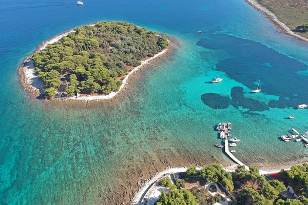 Aerial view of a speedboat in the bright turquoise Blue Lagoon near Trogir, Croatia Aerial view of a speedboat in the bright turquoise Blue Lagoon near Trogir, Croatia