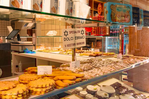 A guided walking tour explores the authentic Cannaregio neighborhood in Venice, passing a local bacaro and quiet canals. A guided walking tour explores the authentic Cannaregio neighborhood in Venice, passing a local bacaro and quiet canals.