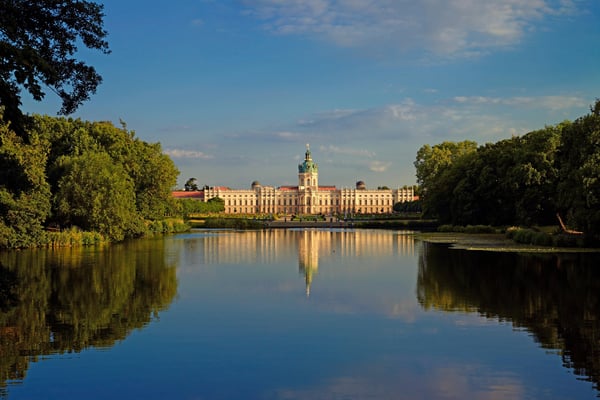 Magnificent front view of Charlottenburg Palace in Berlin with ornate Baroque architecture, manicured gardens, and a central fountain. Magnificent front view of Charlottenburg Palace in Berlin with ornate Baroque architecture, manicured gardens, and a central fountain.