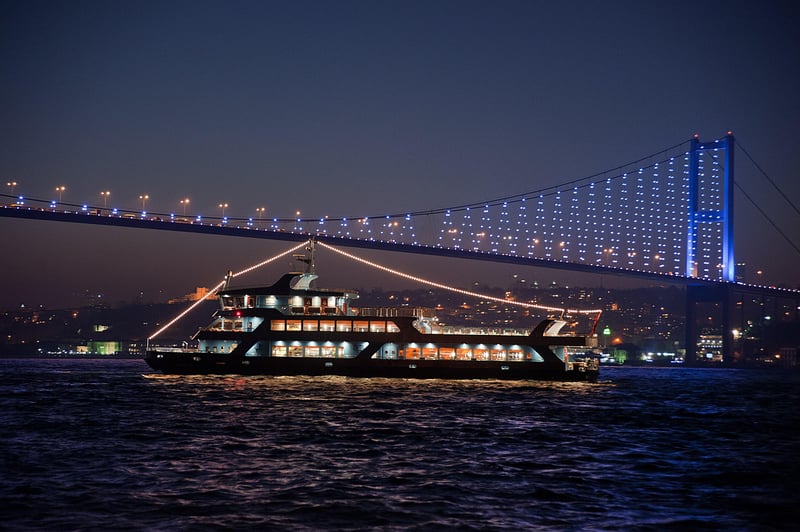 A local mother teaching a hands-on Turkish cooking class in her Istanbul home with guests, preparing traditional dishes in a warm, sunny kitchen. A local mother teaching a hands-on Turkish cooking class in her Istanbul home with guests, preparing traditional dishes in a warm, sunny kitchen.